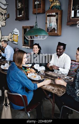 Genießen Sie einen Brunch im Restaurant mit einem Blick auf mehrere ethnische Freunde Stockfoto