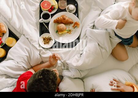 Direkt über der Aufnahme der Familie, die im Bett gefrühstückt hat Hotel Stockfoto