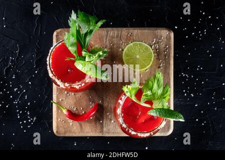 Bloody Mary Cocktail garniert mit Limette und Sellerie, darüber liegende flache Lay Shot Stockfoto