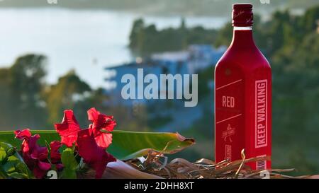 VOLOS, GRIECHENLAND - 30. Nov 2020: Skiathos Island, Griechenland, Flasche Johnnie Walker Red, Blended Scotch Whiskey, bei Sonnenuntergang. Stockfoto