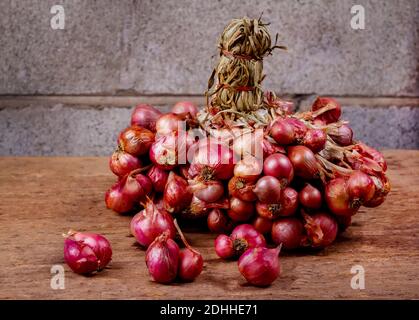 Rote Zwiebeln auf altem Holzhintergrund Stockfoto