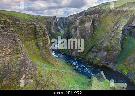 Der Fluss Fjaðrá fließt durch die Schlucht Fjaðrárgljúfur / Fjädrargljufur bei Kirkjubæjarklaustur im Sommer, Island Stockfoto