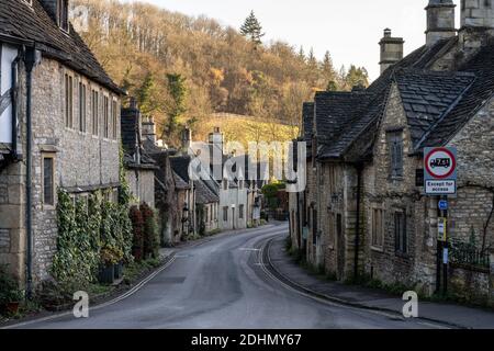 Traditionelle Steinhütten säumen die Straße im malerischen Cotswolds-Dorf Castle Combe in Wiltshire. Stockfoto