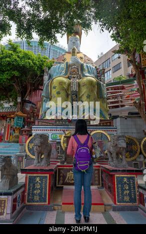 Mädchen verehrt Tin Hau Statue (Godddness of the Sea) in Tin Hau Tempel, Repulse Bay, Hong Kong Island, China Stockfoto
