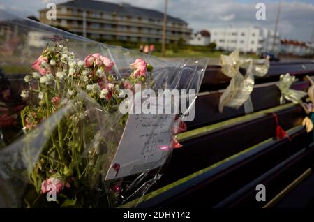 AJAXNETPHOTO. WORTHING, ENGLAND. - ERINNERN - BLUMEN, DIE IM GEDÄCHTNIS VON JEMAND ZURÜCKGELASSEN WERDEN, DER GESTORBEN IST. AUF EINER ÖFFENTLICHEN BANK AUF DER PROMENADE BEI DER MARINE PARADE.FOTO:JONATHAN EASTLAND/AJAX REF:NA130206 551 Stockfoto