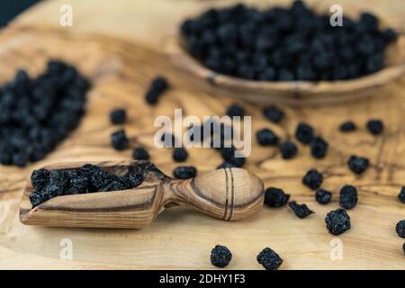 Getrocknete Schwarze Eberesche Aronia-Apfelbeere auf Olivenholz Stockfoto