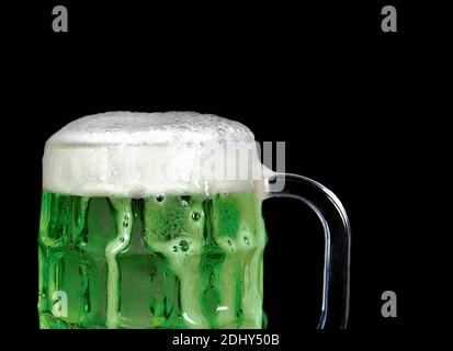 Nahaufnahme von grünem Bier mit Schaum in Glas Tasse Isoliert auf Schwarz Stockfoto