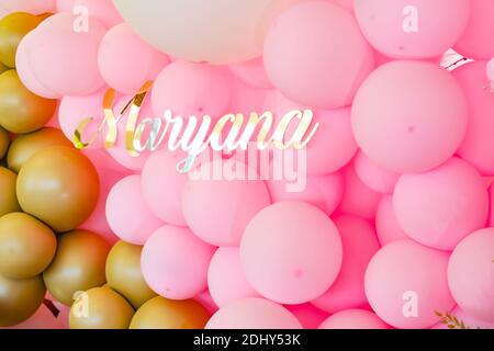 Die Dekoration des Restaurants mit rosa und gold Luftballons zum Geburtstag des Mädchens Mariannіy zu feiern. Der Name Marianne in goldenen Buchstaben geschrieben ist Stockfoto