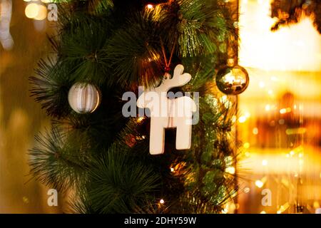 Weihnachtskarte mit Weihnachten Spielzeug, Tannenzweigen und girlande Bokeh. Einrichtung von tannenzweigen und des Neuen Jahres Einrichtung mit traditionellen Holzmöbeln Rotwild, klicken Sie Stockfoto
