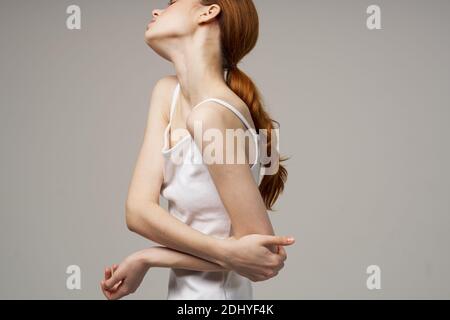 Frau T-Shirt bewegt ihre Hand auf die Seite Ellbogen Emotion Schmerzen Stockfoto