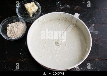 Eine Kuchenform umrühren: Eine runde Kuchenform, die mit Butter und Mehl überzogen ist Stockfoto