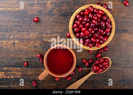 Dogwood Beeren und Kapuze auf einem hölzernen Hintergrund. Stockfoto