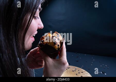 Frau, die einen Schokoladenmuffin isst Stockfoto