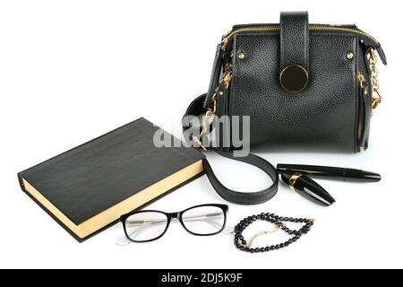 Elegantes Set von Accessoire für Frauen. Tasche, Brille, Buch, Kosmetik und Perlen isoliert auf weißem Hintergrund Stockfoto