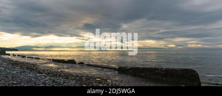 Panoramablick auf die Olympic Peninsula von der Admiralty Inlet. Wolken tief über Wasser leuchten hell mit der Abendsonne I vor der Olympischen Mounta Stockfoto