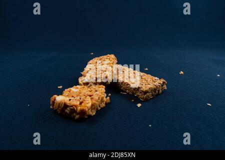 Fitness Müsliriegel mit Stücken auf schwarzem Hintergrund Stockfoto