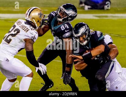 Philadelphia, PA, USA. Dezember 2020. 13. Dezember 2020: Philadelphia Quarterback Jalen Hurts trifft auf einen Teamkollegen, als er während des NFL-Fußballmatchup zwischen den New Orleans Saints und den Philadelphia Eagles am Lincoln Financial Field in Philadelphia, Pennsylvania, in Angriff genommen wird. Scott Serio/Cal Sport Media/Alamy Live News Stockfoto