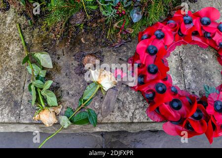 London/UK. 12.2.20. Remembrance day poppies left next to the war memorial in the atmospheric western part of Highgate Cemetery in north London Stock Photo