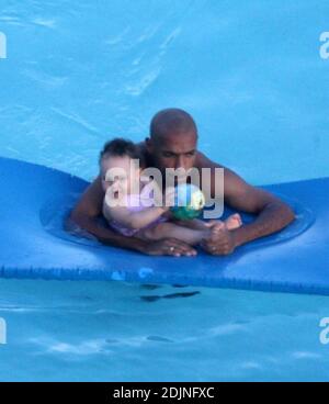 Exklusiv!! Frankreich und Arsenal Fußball-Ass Thierry Henry gibt Tochter Tee einige Lektionen in Schwimmen und Ballkontrolle. Frau Nicole Merry, die den Morgen mit Sonnenbaden verbrachte, schaute auf und wie jede stolze Mutter mit ihrer Digitalkamera wegschnappte. Am Morgen sonbte Nicole jeden Tag eineinhalb Stunden lang solo, während sie auf ihrem Mobiltelefon plauderte, non-stop, Miami Beach, FL, 7/25/06 Stockfoto