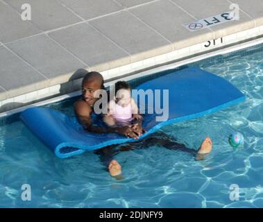 Exklusiv!! Frankreich und Arsenal Fußball-Ass Thierry Henry gibt Tochter Tee einige Lektionen in Schwimmen und Ballkontrolle. Frau Nicole Merry, die den Morgen mit Sonnenbaden verbrachte, schaute auf und wie jede stolze Mutter mit ihrer Digitalkamera wegschnappte. Am Morgen sonbte Nicole jeden Tag eineinhalb Stunden lang solo, während sie auf ihrem Mobiltelefon plauderte, non-stop, Miami Beach, FL, 7/25/06 Stockfoto