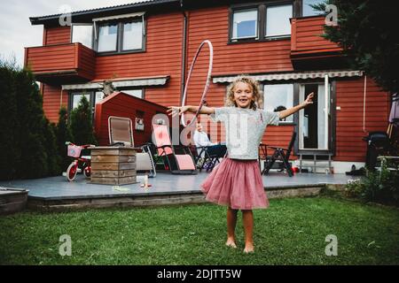 Nettes Mädchen in Tutu spielen mit Hula Hoop in ihr Hinterhof in Norwegen Stockfoto