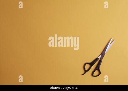 Special scissors for work of hairdresser on yellow background Stock Photo