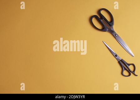 Special scissors for work of hairdresser on yellow background Stock Photo