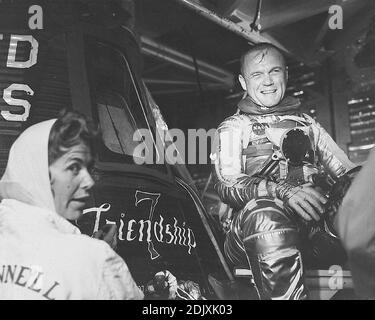 Astronaut John H. Glenn Jr., Pilot der Mercury-Atlas 6 'Friendship 7' Mission, ist während der Flugaktivität am Cape Canaveral neben seiner Kapsel aufgesetzt und sitzt. Glenn wird mit der Künstlerin Cecilia Bibby gezeigt, die den Namen 'Friendship 7' auf seinem Merkur-Raumschiff malte. Foto der NASA via CNP/ABACAPRESS.COM Stockfoto