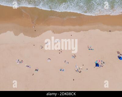 Gruppe von Menschen am Strand von direkt oben gesehen Stockfoto