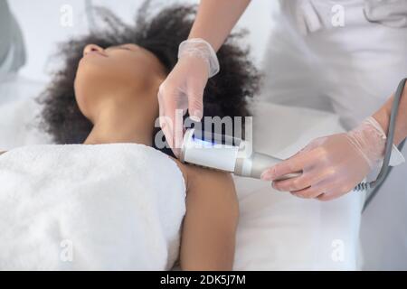 Girl lying on couch during cosmetic procedure Stock Photo