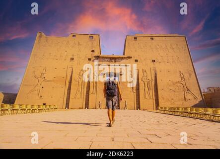 Ein junger Tourist in den Tempel von Edfu in der Stadt Edfu bei Sonnenuntergang, Ägypten. An den Ufern des Nils, geco-Roman Bau, Stockfoto