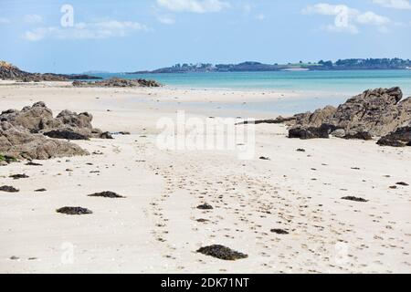 Along the beach of the tidal island of Ebihens near Saint Malo in Brittany, France with a view to Saint-Briac-sur-Mer Stock Photo