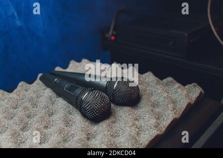 Two silver microphones isolated over white background . Two wireless microphones on the conference table Stockfoto