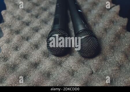Two silver microphones isolated over white background . Two wireless microphones on the conference table Stockfoto