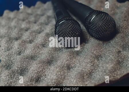 Two silver microphones isolated over white background . Two wireless microphones on the conference table Stockfoto