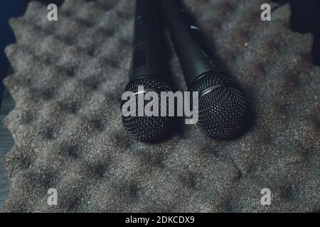 Two silver microphones isolated over white background . Two wireless microphones on the conference table Stockfoto