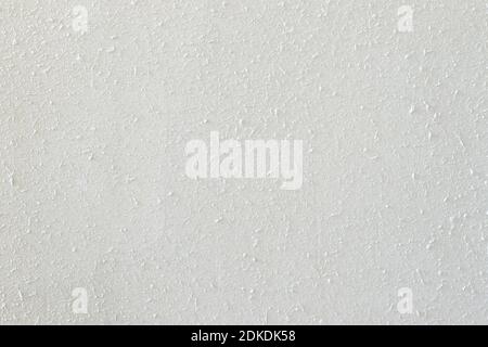 Abstrakte weiße Textur der Betonwand, Nahaufnahme Hintergrund mit kleinen Details von Spritzern und Beulen von Zement Stockfoto