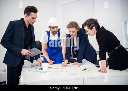 Group Of Four Business People Working Together In Office. Stockfoto