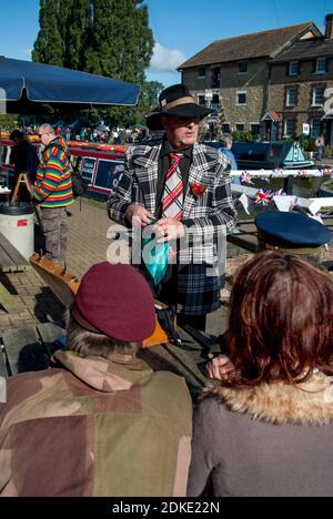 Re-enactors in forties costume with a spiv impersonator at centre, Village at War event, Stoke Bruerne, Northamptonshire, UK Stock Photo