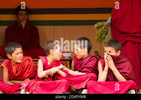 Lamayuru, Indien - 17. Juni 2012: Unruhige Jungen Mönche als Zuschauer beim Cham Dance Festival of Tibetan Buddhism im Lamayuru Kloster, Ladakh, Indi Stockfoto