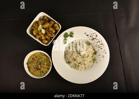 Jeera Reis serviert mit Kartoffelchaat und Dal braten Stockfoto