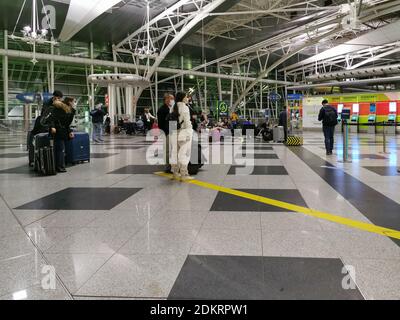 Porto / Portugal 09 25 2020: Interior view of the Lisbon airport building, with people with covid masks walking with suitcases and bags and resting on Stock Photo