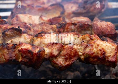 aromatic fresh grilled meat skewered on a grill in the fresh air Stock Photo