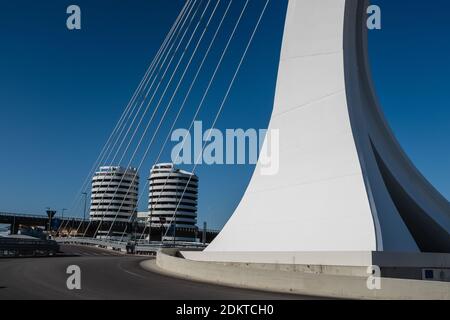 Street level view of Ennio Flaiano Bridge, a cable-stayed bridge with a single pylon located in the center of a traffic circle. Stock Photo