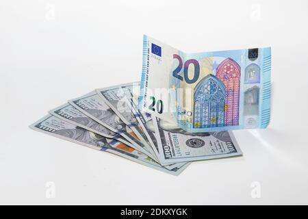 Twenty euro note on top of one hundred dollar bills Stock Photo