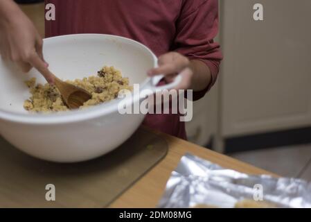 Herstellung von Schokoladenstückchen Backen und Mischen des Teigs Stockfoto