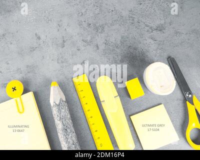 office desk with accessories background on trendy colors, school yellow supplies on a ultimate gray background. Flat lay, top view. Back to school con Stockfoto