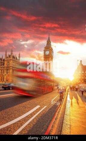 Big Ben mit rotem Bus gegen farbenfrohen Sonnenuntergang in London, England, Großbritannien Stockfoto