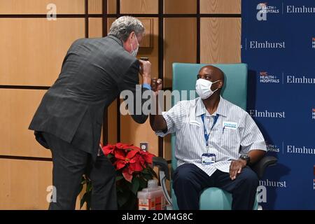 New York, USA. Dezember 2020. Der Bürgermeister von New York, Bill de Blasio, gratuliert seiner Service Aide Kelly Willaim, nachdem er die erste Dosis des Impfstoffs Pfizer-BioNTech COVID-19 an den NYC Health Hospitals/Elmhurst im Stadtteil Queens von New York City, NY, am 16. Dezember 2020 erhalten hat. NYC Health Hospitals/Elmhurst ist das erste öffentliche Krankenhaus in New York City, das seine Mitarbeiter im Gesundheitswesen gegen das Coronavirus geimpft hat und plant, alle wichtigen medizinischen Fachkräfte innerhalb von 3 Wochen impfen zu lassen. (Foto von Anthony Behar/Sipa USA) Quelle: SIPA USA/Alamy Live News Stockfoto