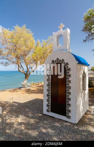 Small whitewash Greek Orthodox shrine at the seaside in Tavronitis, Crete, Greece Stock Photo